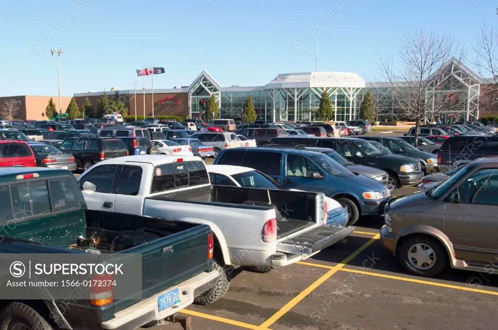 Vehicles filling parking lots outside a mall