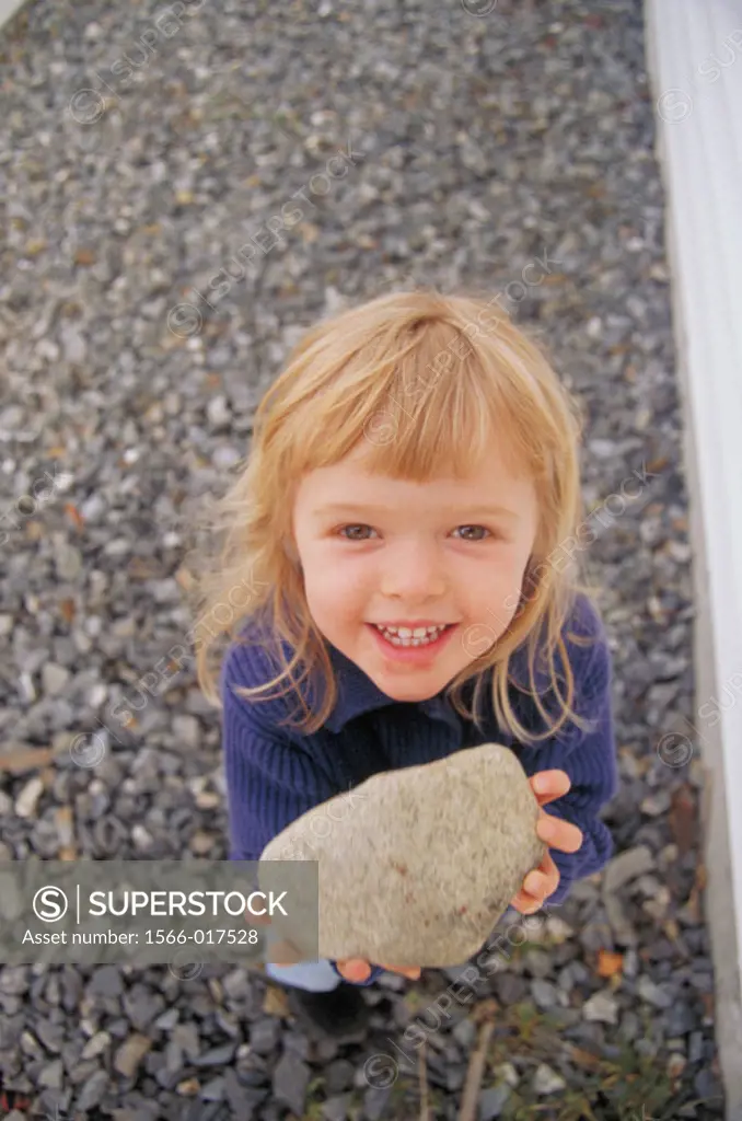 Little girl holding a rock