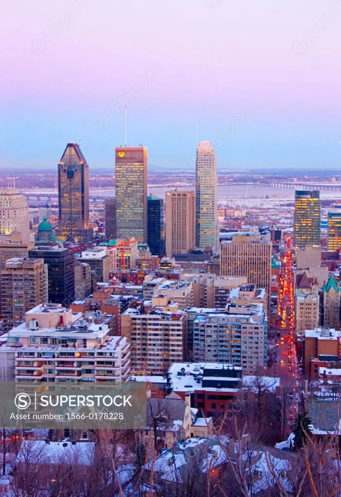 View of downtown Montreal skyline and South Shore from atop Mount Royal (Mont Royal) in winter during sunset. Quebec, Canada