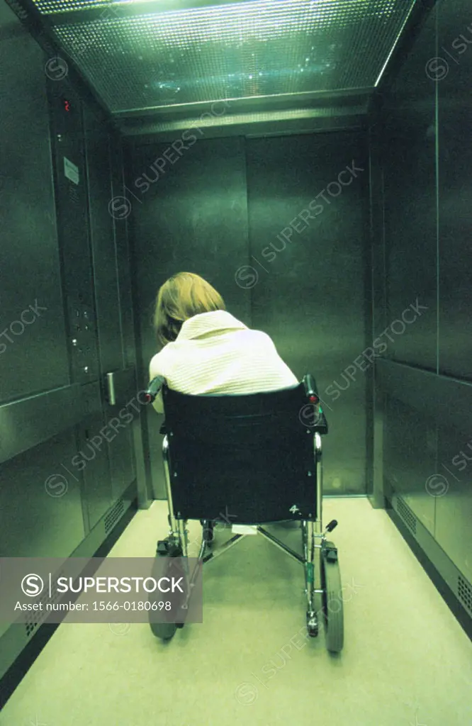 Patient in wheelchair in hospital lift