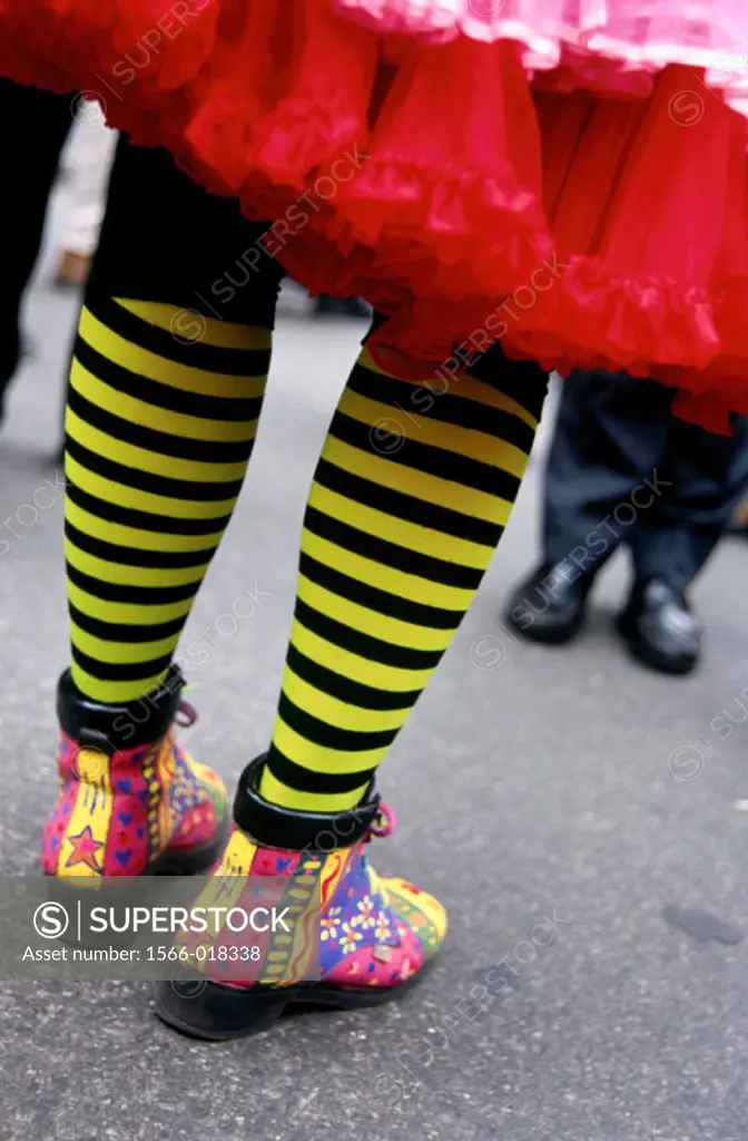 back side and partial leg view of colorful stockings and shoes of a clown