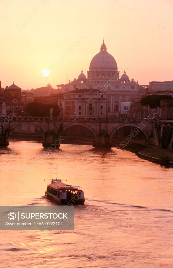 View on St. Angelo bridge over Tiber river and St. Peter´s basilica in background. Vatican City, Rome. Italy