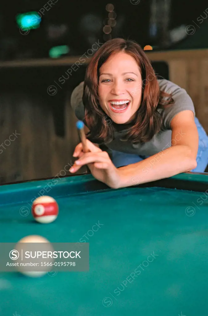 girl shooting pool