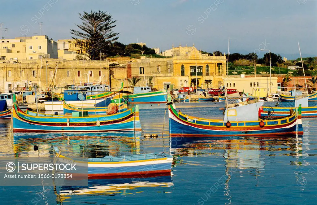 Local fishing boats or Luzzu, decorated with Osiris eyes for good luck. Marsaxlokk. Malta.