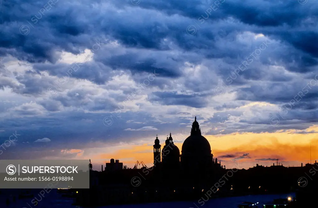 Stormy sky. La Salute church. The Grand Canal at dusk. Venice. Italy.