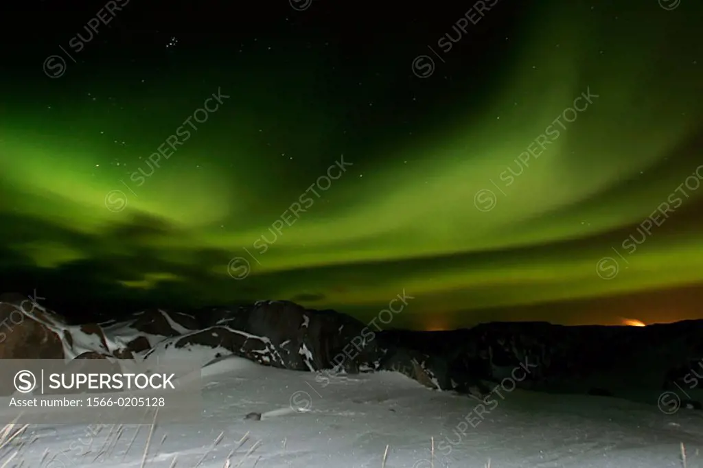 Aurora Borealis (northern Lights) over the snow covered shore of Hudson Bay, Churchill, Manitoba, Canada.