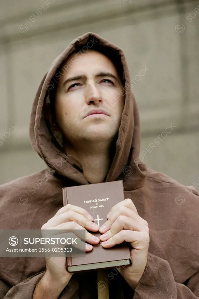 Monk. Priest holding Bible.