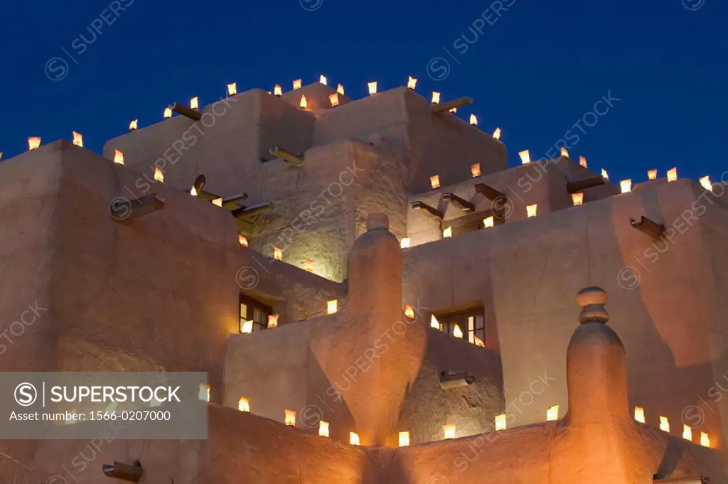 Adobe walls and luminaria candles at Inn and Spa at Loretto in the evening. Santa Fe. New Mexico, USA