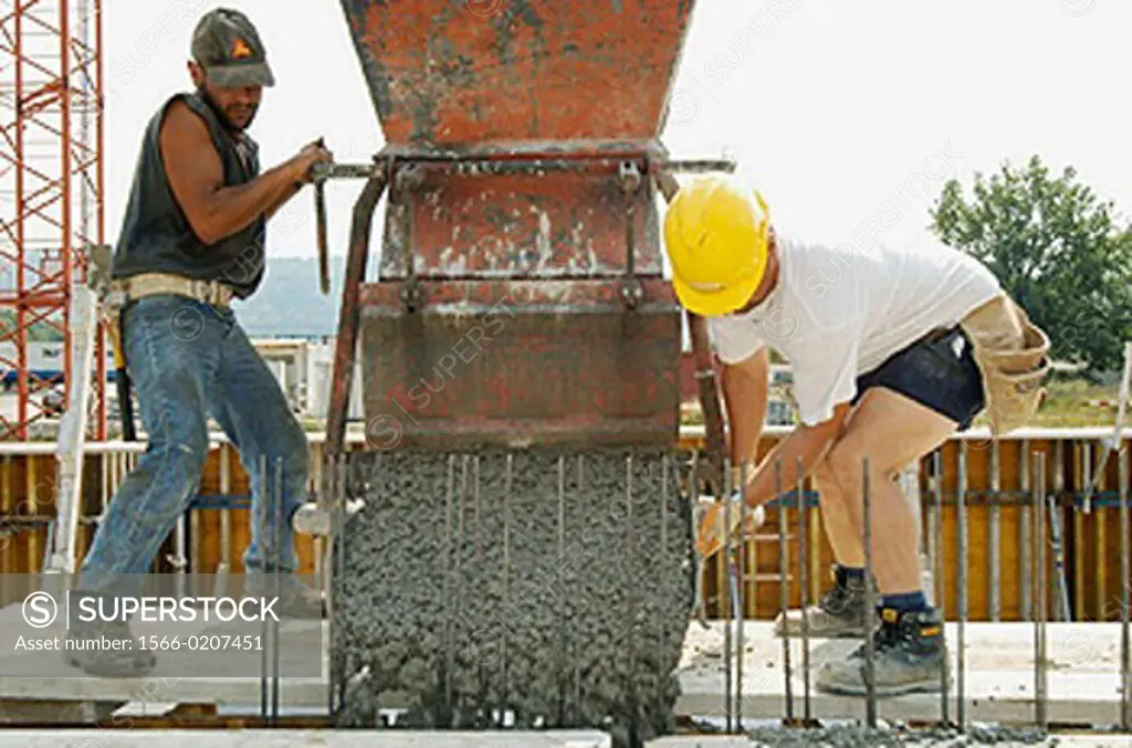 Construction workers preparing a concrete fill at construction site in Switzerland