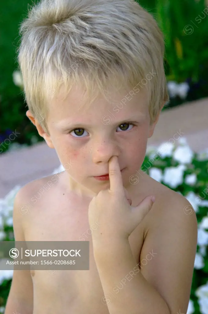 boy with finger up his nose
