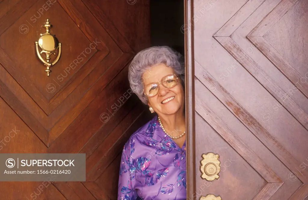 Old woman smiling at doorstep