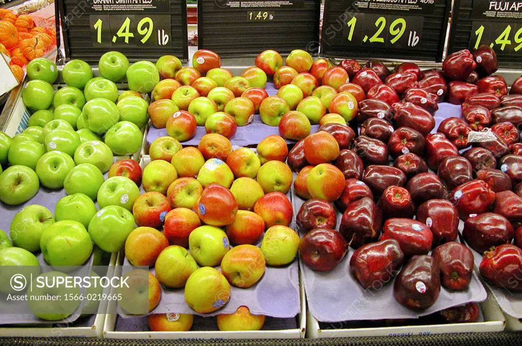 Apples on display with prices in a supermarket.