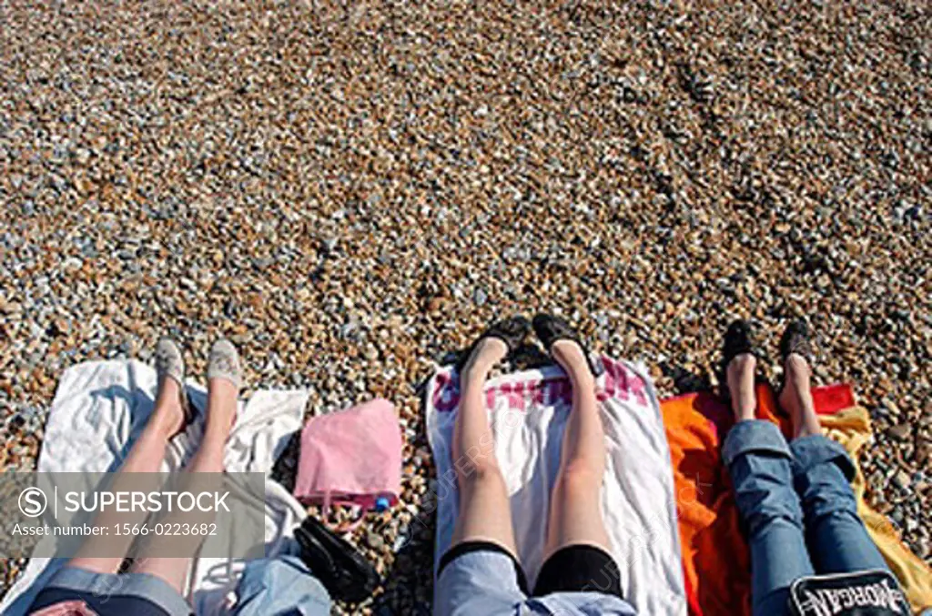 Young women legs on a beach