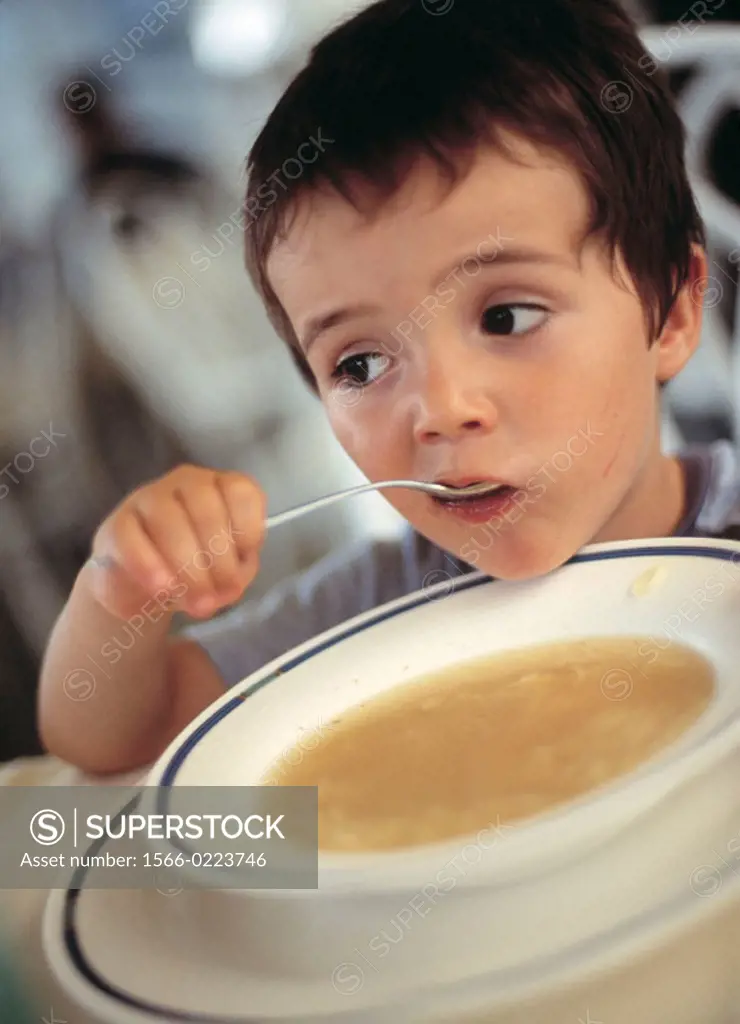 Boy eating soup