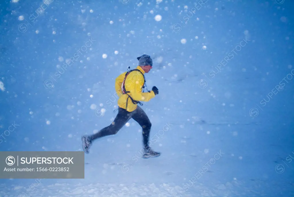 Man running in the snow in winter on Donner Summit, California. USA