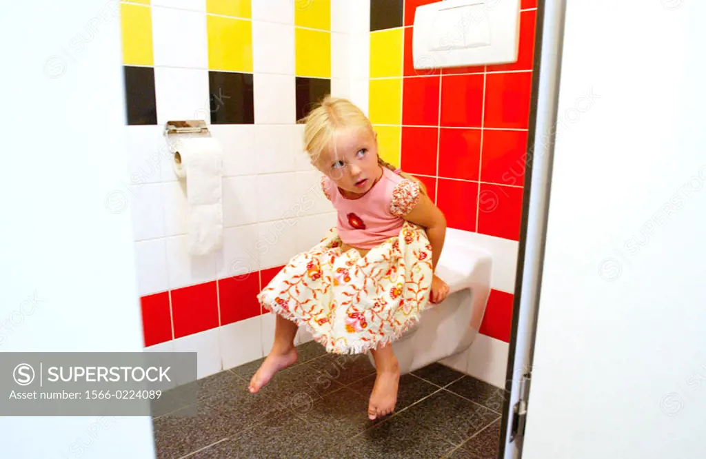 Child sits on toilet