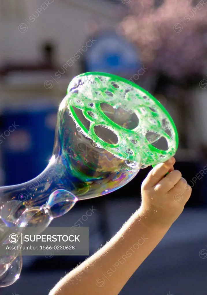 child using bubble wand