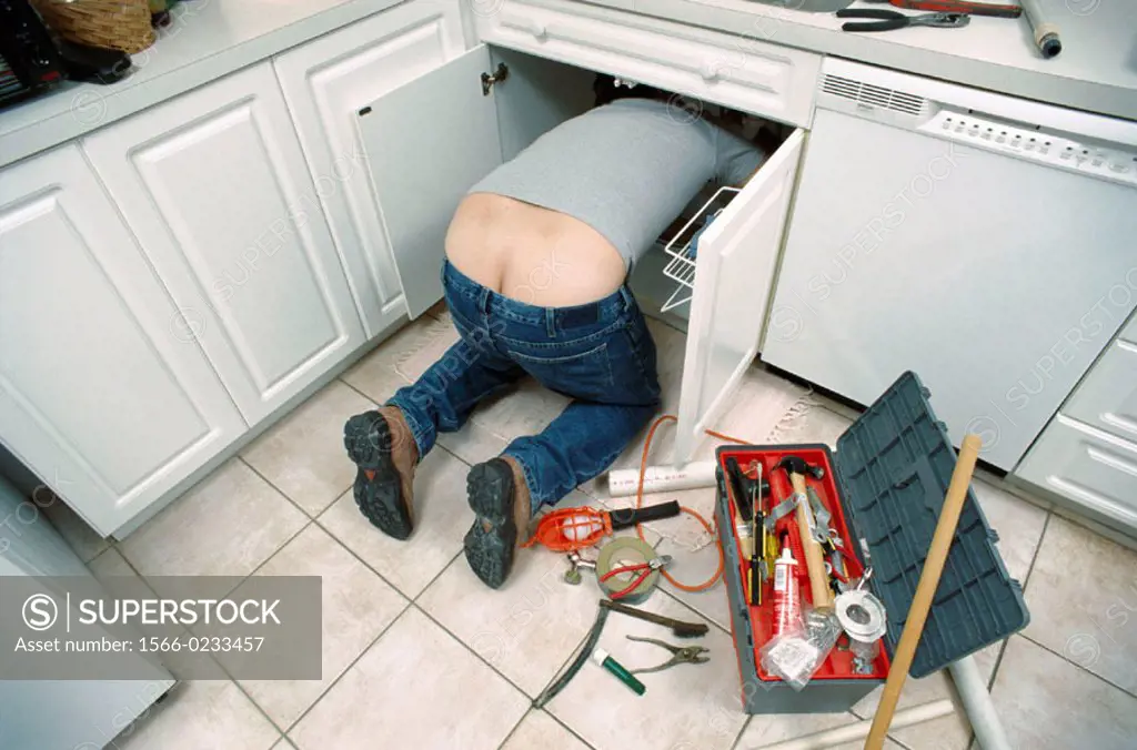 plumber under kitchen sink