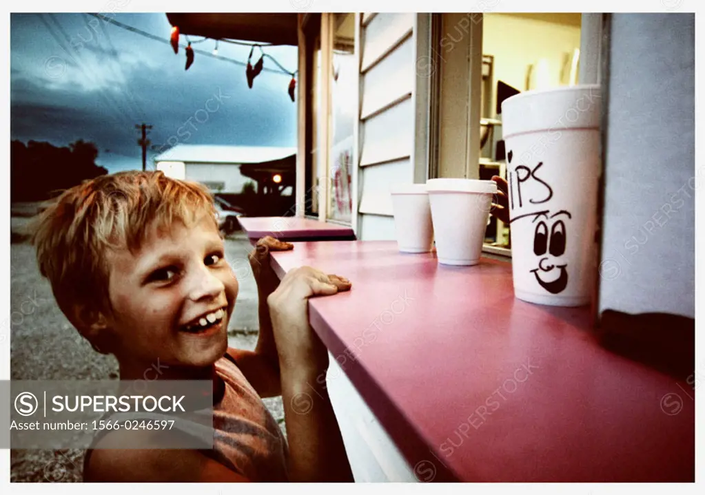 Smiling boy at ice cream stand. Indiana, USA