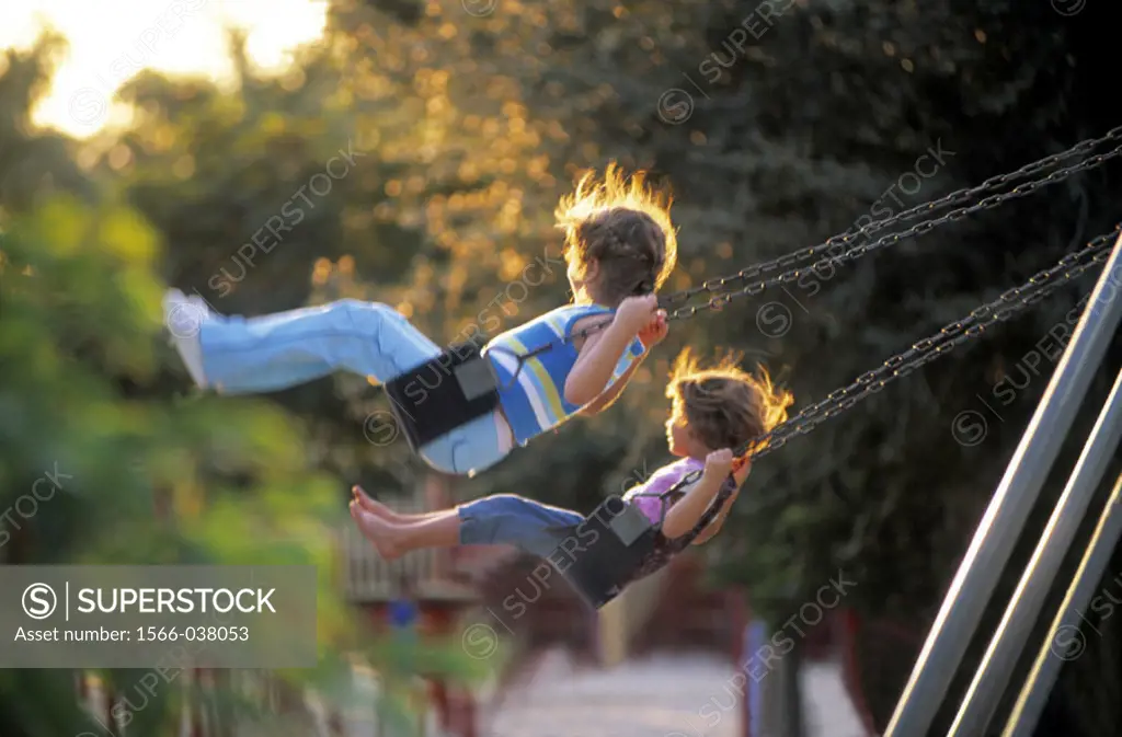 Girls on a swing in a playground