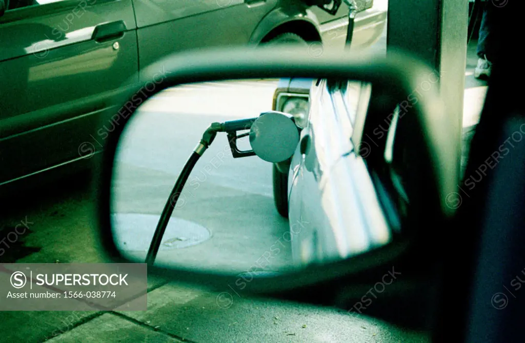 View of gas pump in car´s rearview mirror