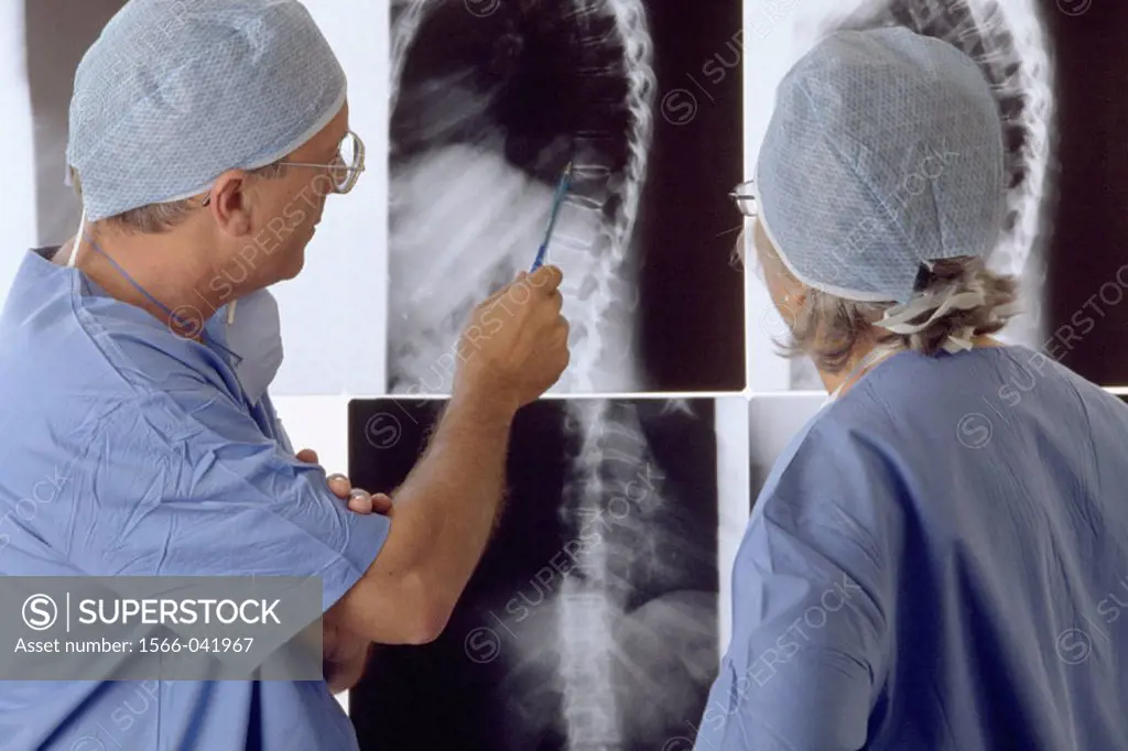 Surgeons studying X-rays