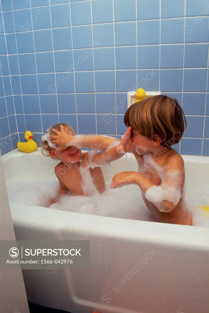 Two rambunctious brothers in bubble bath