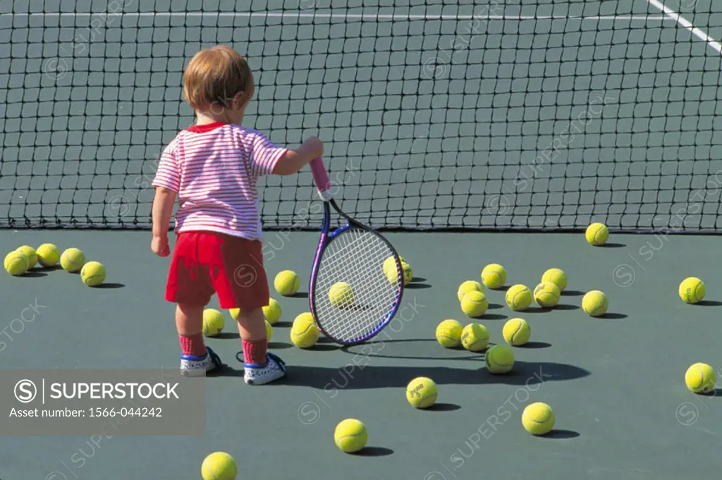 Young child holding tennis racquet