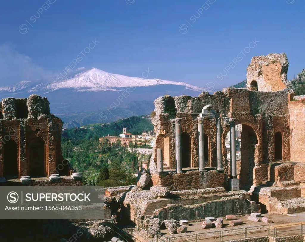Etna Volcano and ruins of the old Greek theatre. Taormina. Sicily. Italy