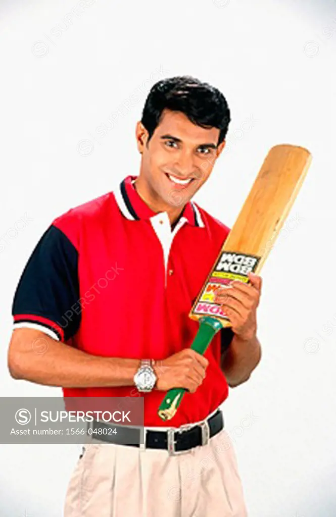 Smiling athlete holding cricket bat