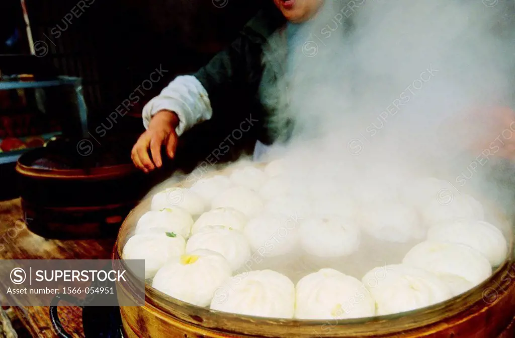 Cooking Dim Sum in a popular market by a canal. Suzhou. Kiangsu province, China