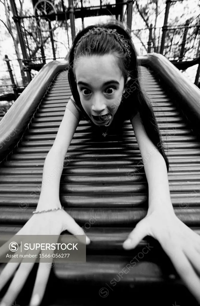 Girl sliding board. Carl Schurtz Park. New York City. USA