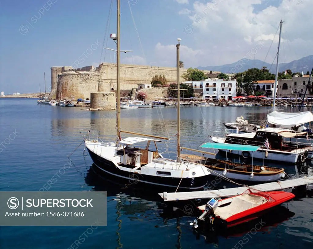Boats at port and old 12th-century castle fortress in background. Kyrenia. Cyprus