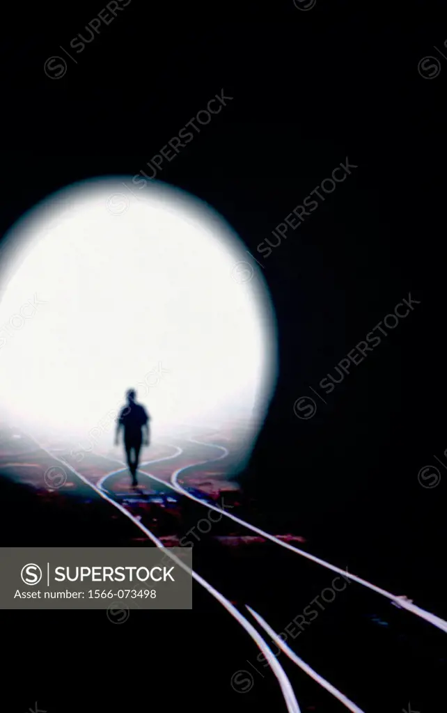 Man walking out of railroad tunnel.