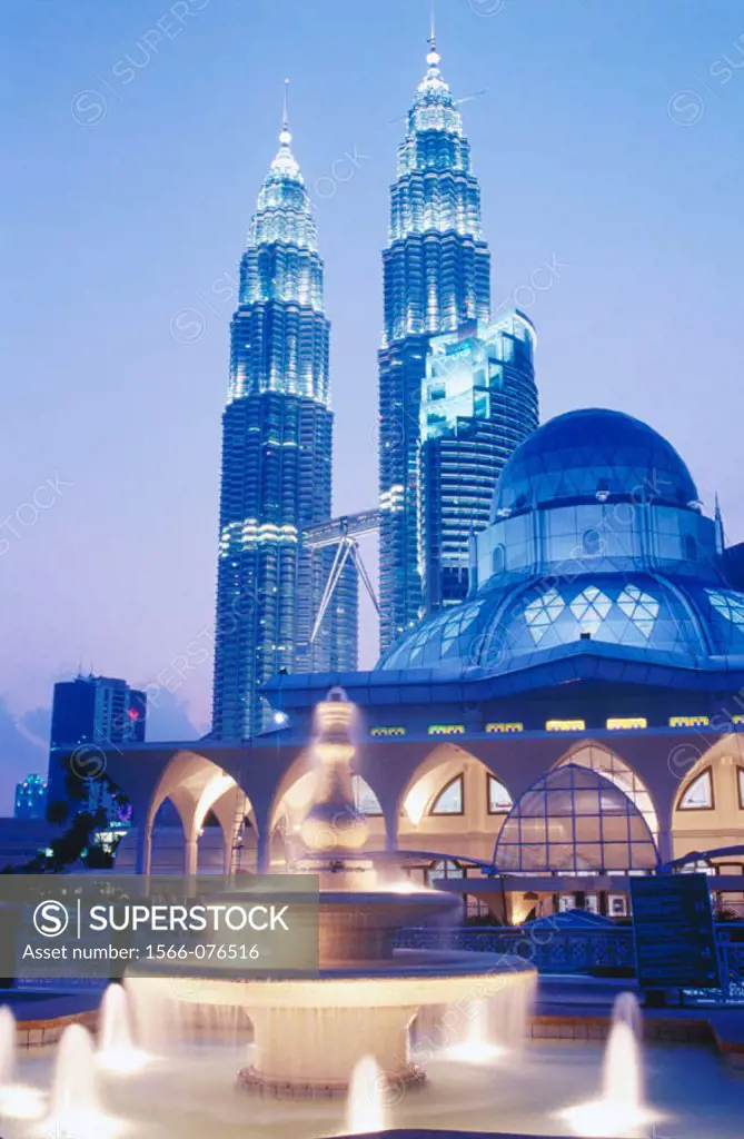 Petronas twin towers (the tallest building in the world),  Asy-Syakirin Mosque in the KLCC Park in foreground. Kuala Lumpur. Malaysia