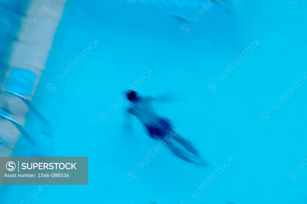 Blurred picture of a man swimming in a pool