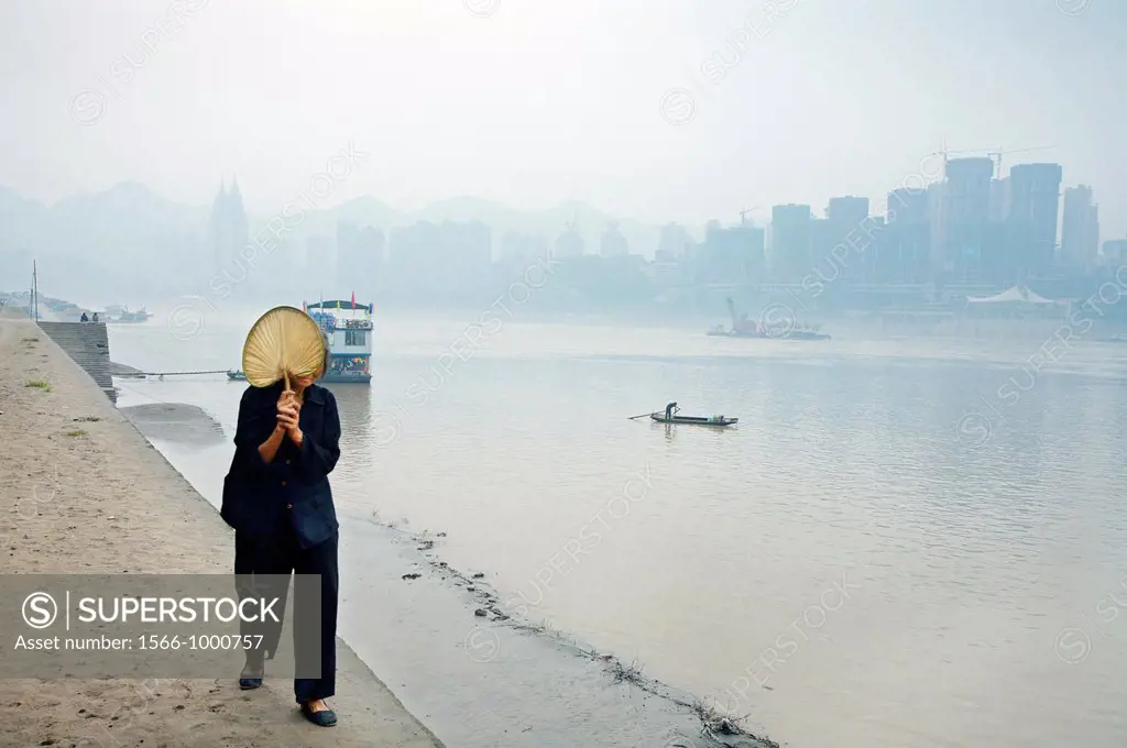 Widow, she cover her face each time she passes close to other people so no person can see her face, Chongqing , Sichuan Province, Yangtze River, China...