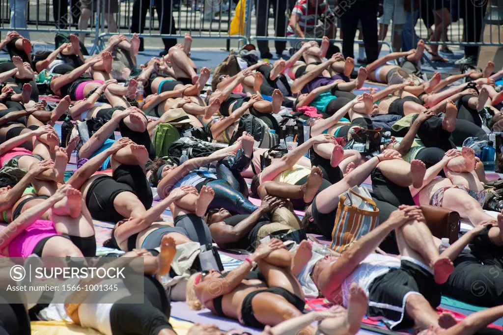Thousands of yoga practitioners in Times Square in New York participate in a mid-day Bikram Yoga class on the first day of summer Temperatures are exp...