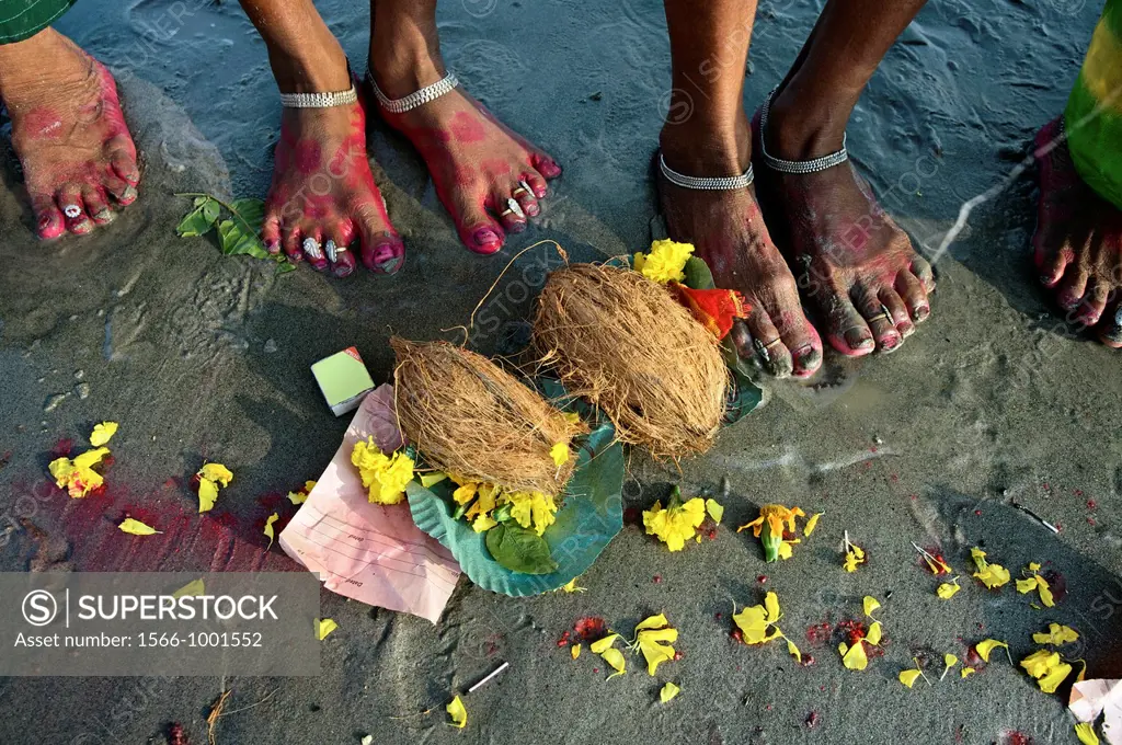 Pilgrims making offerings at the confluence of the river Ganges and the Bay of Bengal , Sagar Mela, India, Ganges River.