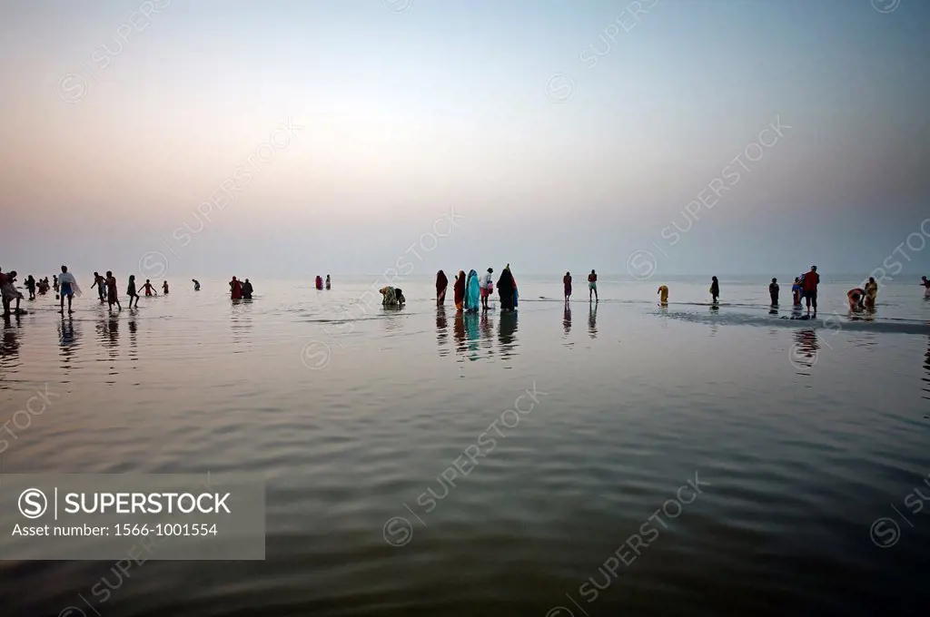 Pilgrims bathing at the confluence of the river Ganges and the Bay of Bengal , Sagar Mela, India, Ganges River.