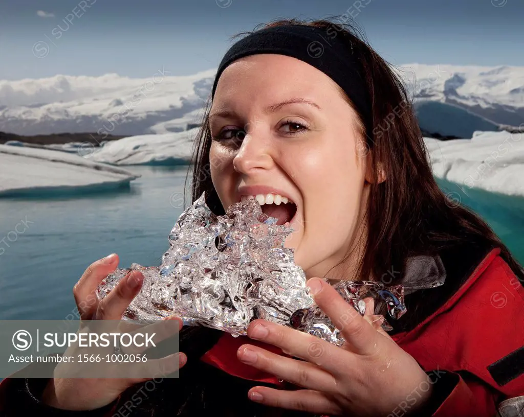 Woman tasting glacial ice, Jokulsarlon Glacial Lagoon, Iceland