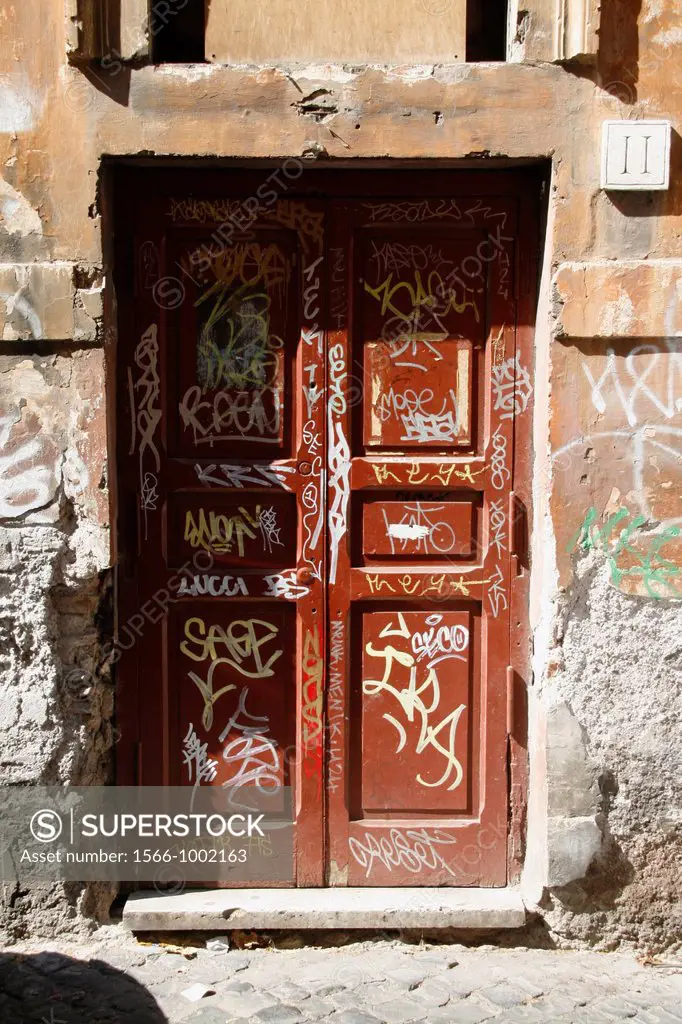 lots of covered graffiti on wooden door