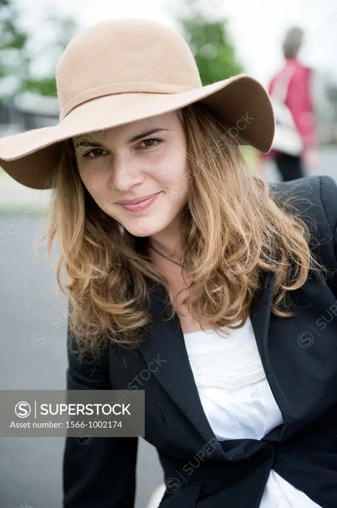 Rotterdam, Netherlands  Portrait of a young, attractive brunette with hat and long, strait hair 
