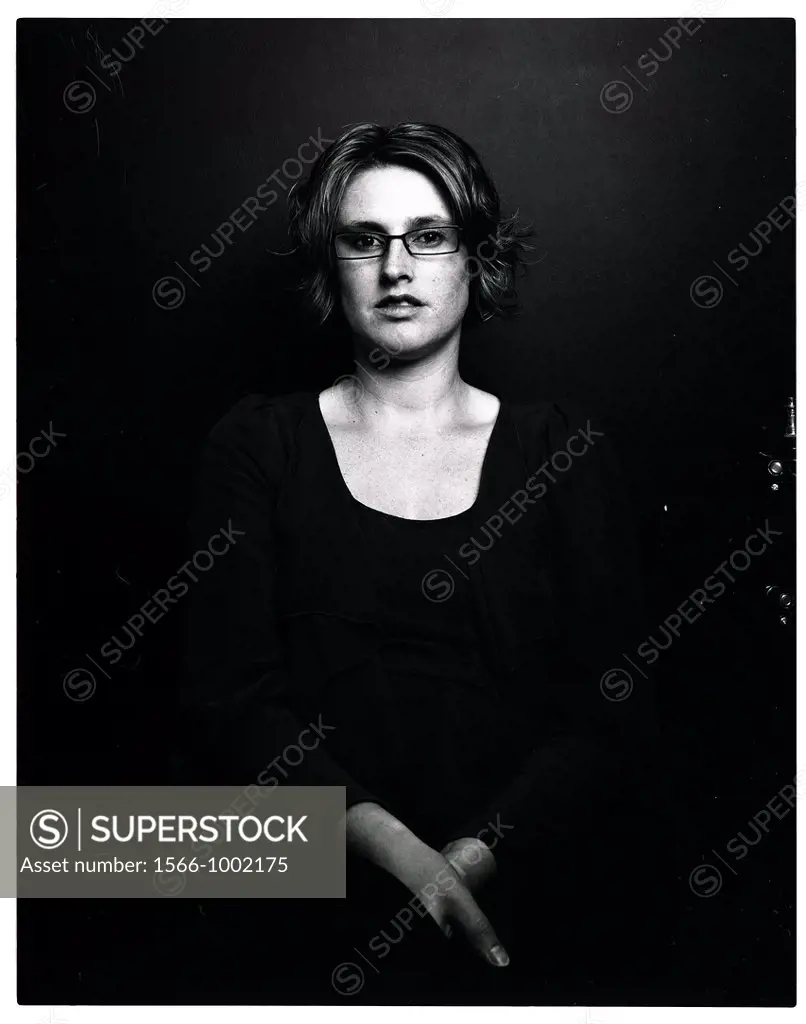 Rotterdam, Netherlands. Analog black and white portrait of a young adult woman, wearing glasses due to poor eyesight. Image produced using a 6 X 7 bla...