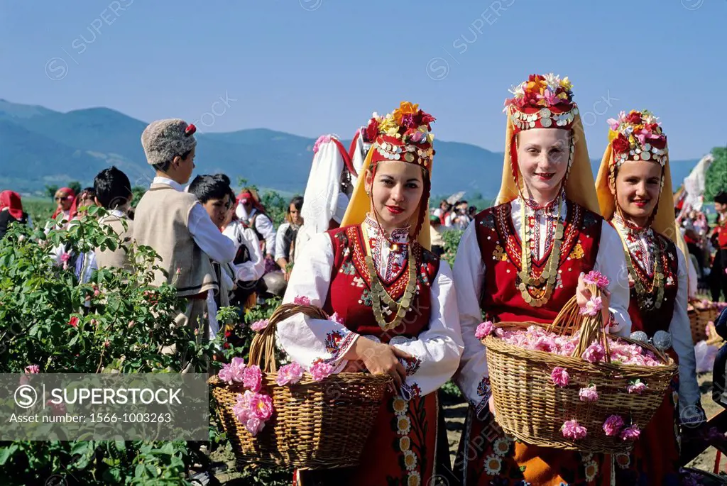 traditional dressed young girls in a rose garden during the Rose Festival in the Rose Valley, Kazanlak, Bulgaria, Europe