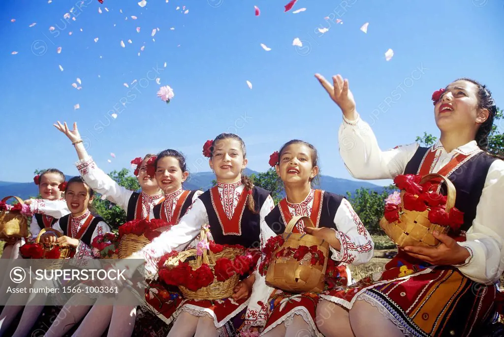traditional dressed young girls in a rose garden during the Rose Festival in the Rose Valley, Kazanlak, Bulgaria, Europe