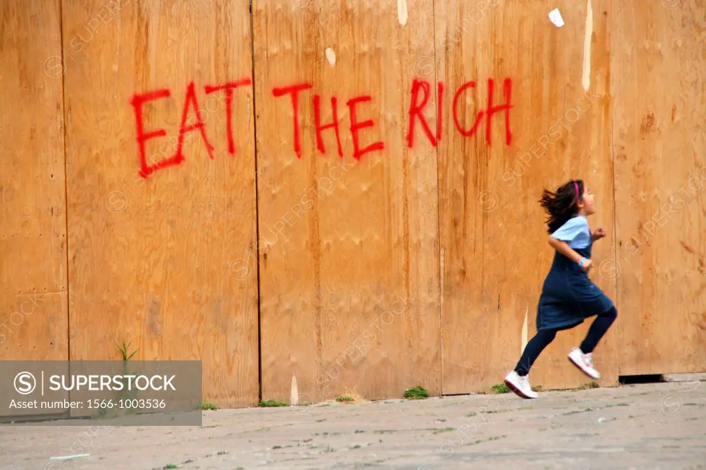 eat the rich graffiti on wall in palermo, sicily, italy