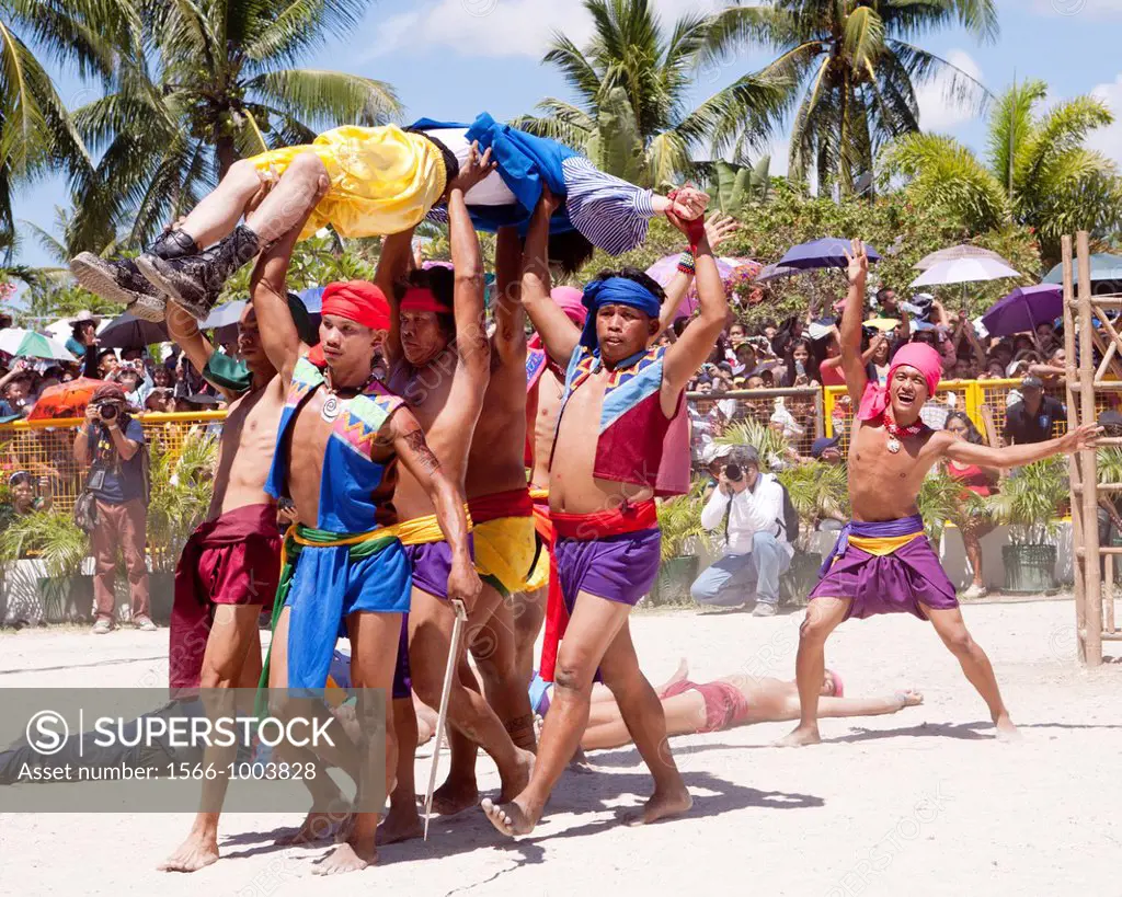 The native warriors celebrate victory and the death of Magellan at the Battle of Mactan reenactment or Kadaugan Festival, carrying his body  The Battl...