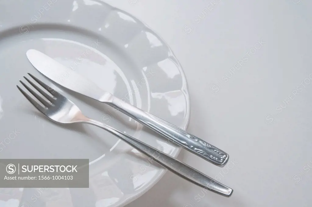 Fork and knife on an empty plate