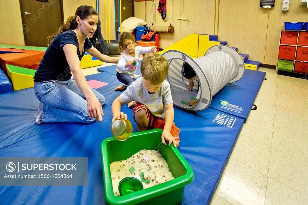 Blind and vision-impaired children sift sand to improve their tactile perception in a sensory motor group at the Blind Children´s Learning Center in S...